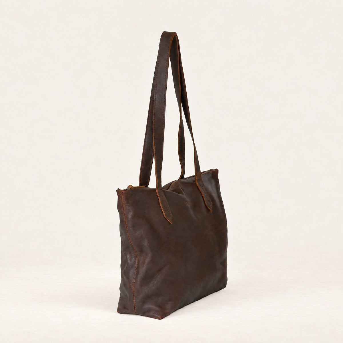 Rowdy Leather Tote Bag in Maple (smooth aniline leather), three-quarter view showing the zip top