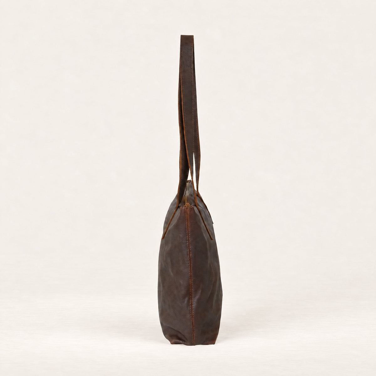 Rowdy Leather Tote Bag in Maple (smooth aniline leather), side view showing its slim 12 cm depth