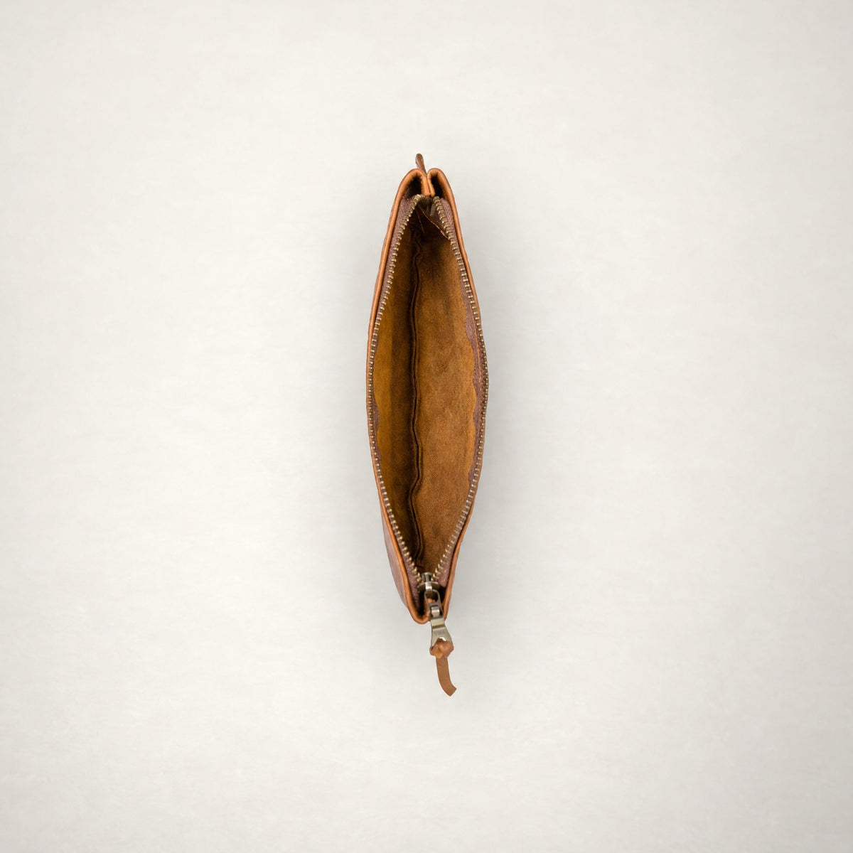 Rowdy leather Travel Pouch in Cedar, unzipped from above to show the soft unlined interior.