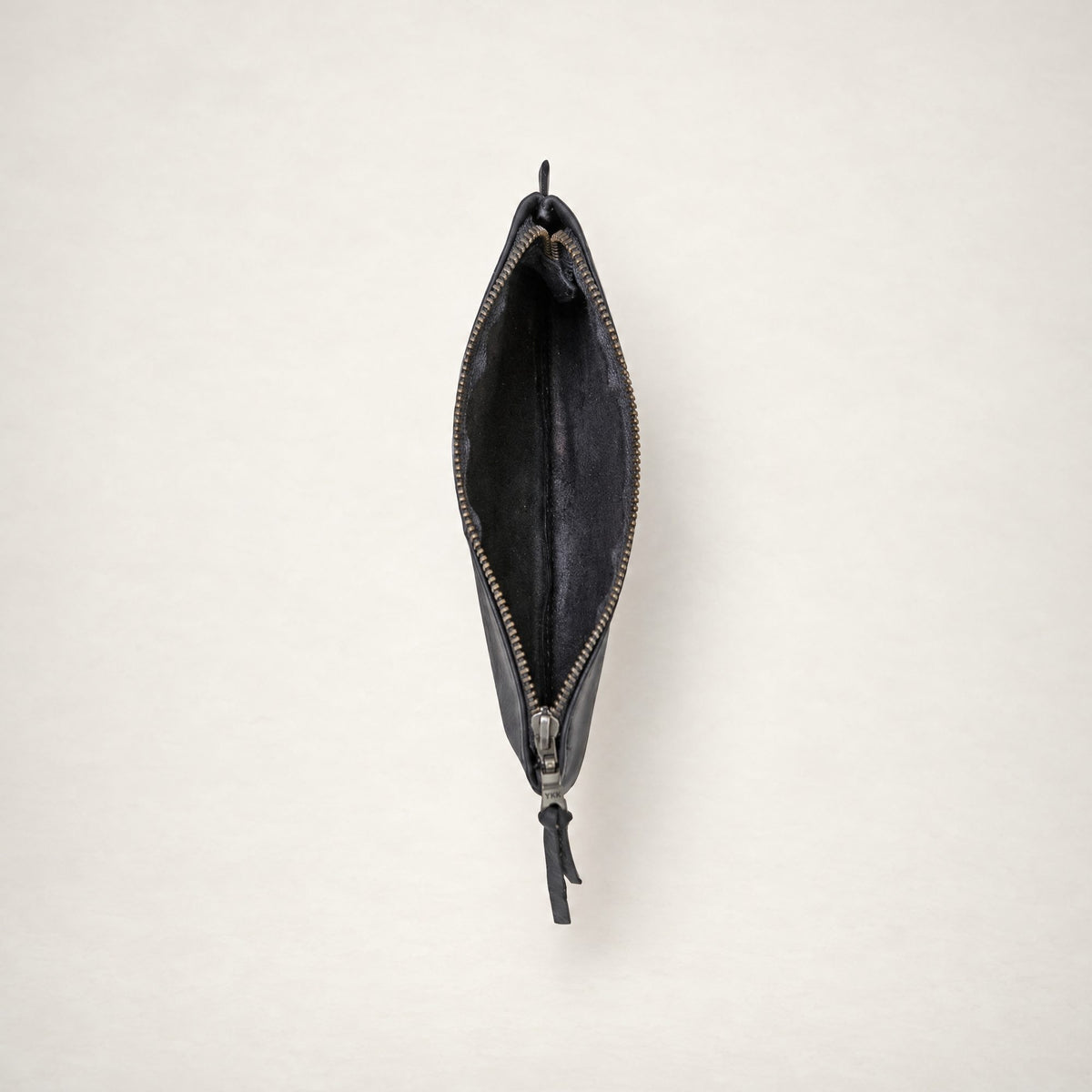 Rowdy leather Travel Pouch in Charcoal, unzipped from above to show the soft unlined interior.