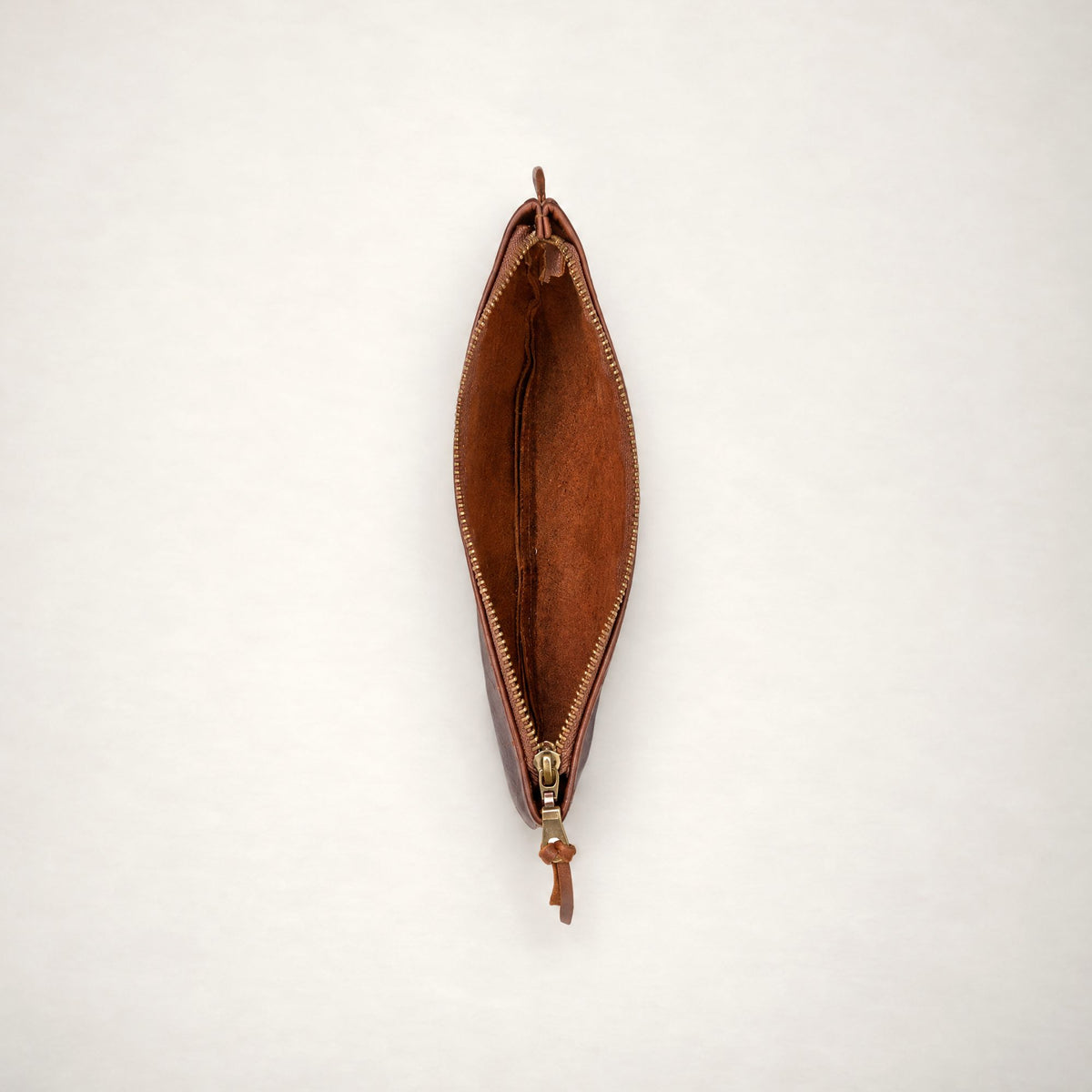 Rowdy leather Travel Pouch in Maple, unzipped from above to show the soft unlined interior.