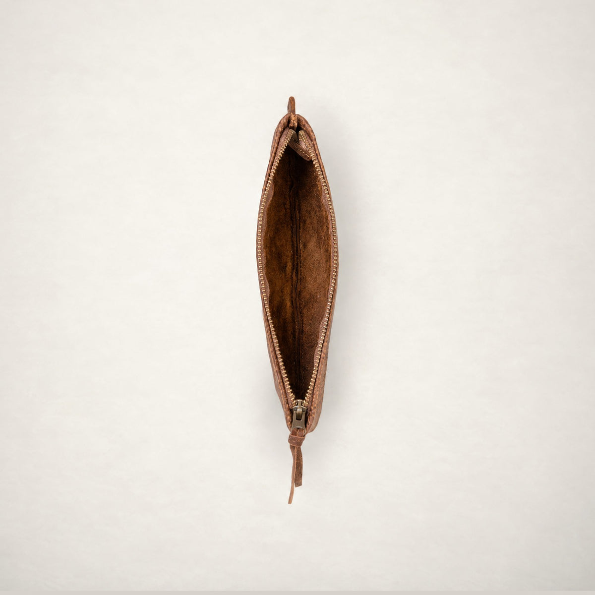 Rowdy leather Travel Pouch in Mountain, unzipped from above to show the soft unlined interior.