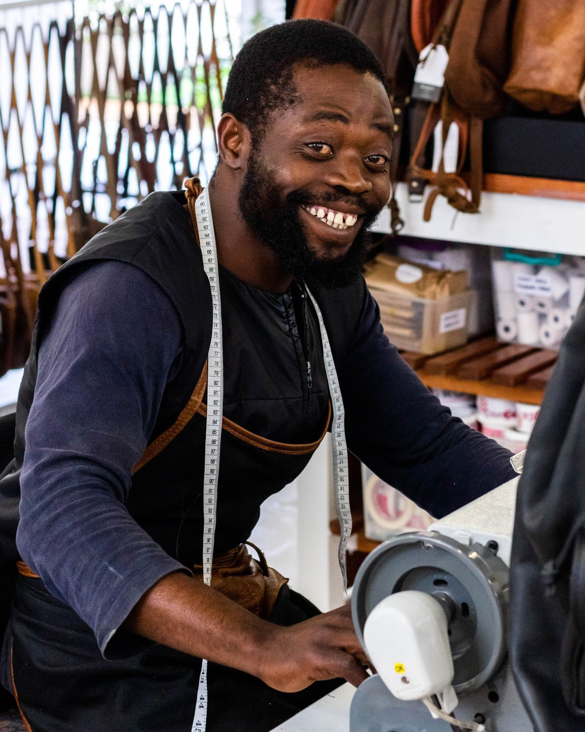 Robert, one of our makers, smiling at his workbench in our Cape Town workshop