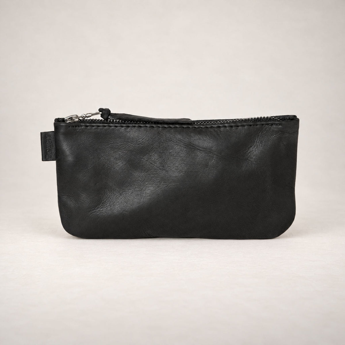 Rowdy leather Travel Pouch in Charcoal (black leather), with a full-length zip, for passport, phone and cards