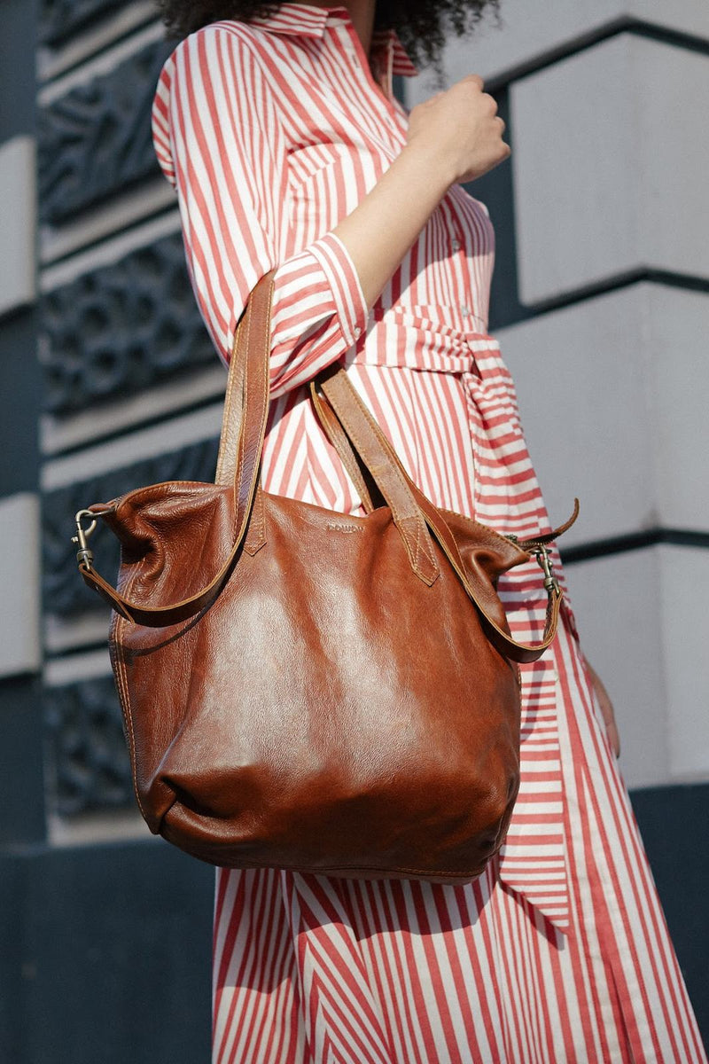 Red and white striped shirt dress with the Rowdy Leather Crossbody Bag carried on the shoulder