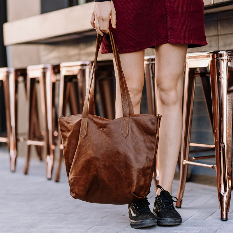 Rowdy Leather Tote Bag carried by hand by its leather straps