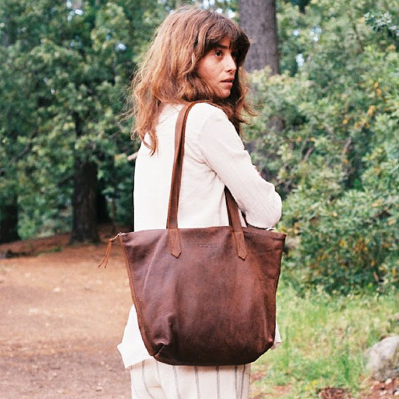 Woman on a woodland path with the Rowdy Leather Tote Bag on her shoulder